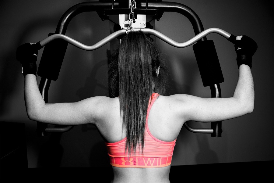 Upper Body Workout Ideas for Women Woman Working Out Her Back on an Exercise Machine