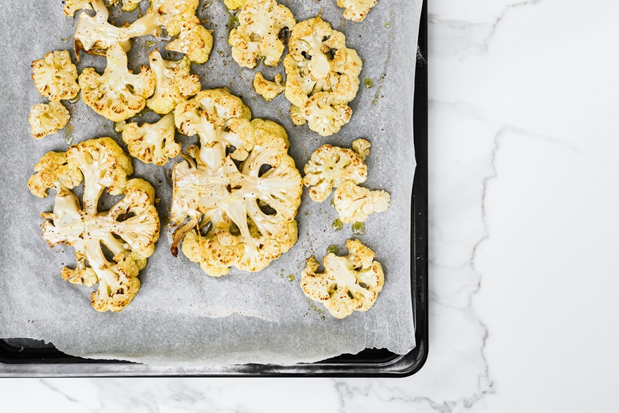 Keto Carb Limit vs Low Carb Limit Cooked Cauliflower on a Baking Sheet