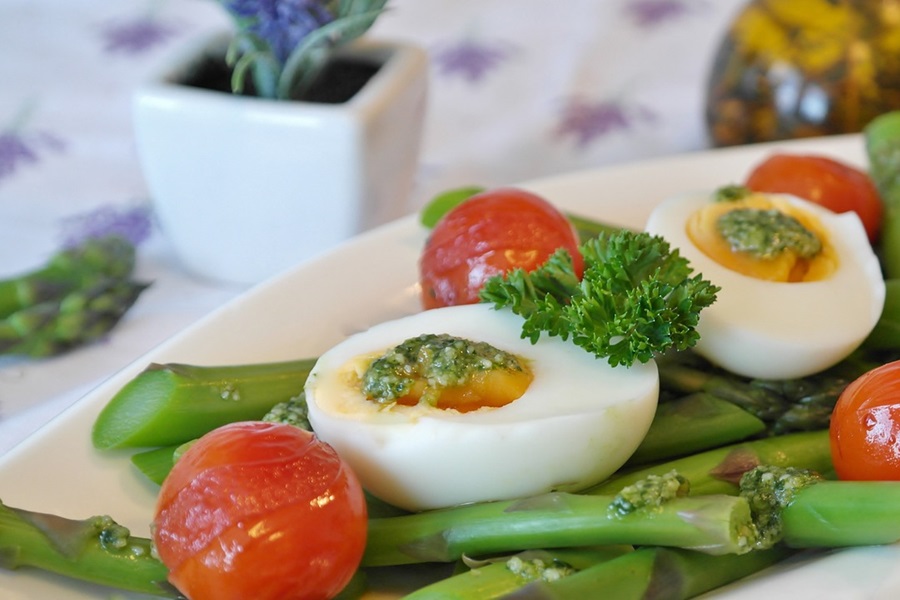 Keto Carb Limit vs Low Carb Limit Close Up of a Hard Boiled Egg on Asparagus