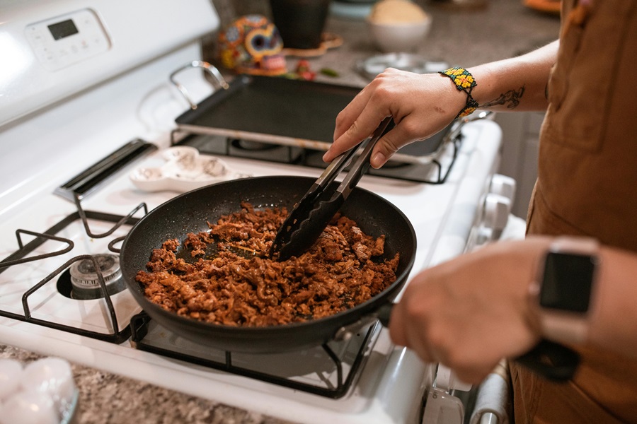 Keto Frito Pie Recipes Close Up of a Person Cooking Ground Beef in a Pan