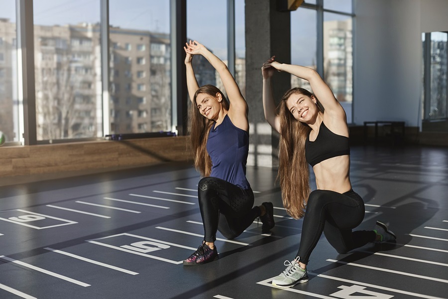 Transform 20 Week 1 Workouts and Tips Two Women Doing Yoga in a Studio