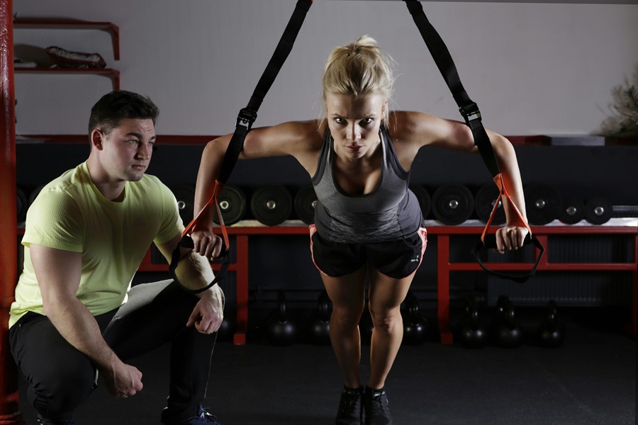 Transform 20 Week 2 Workouts and Tips a Woman Doing a Workout with a Personal Trainer in a Gym