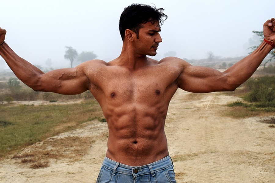 Upper Body Disk Slider Workouts a Man Flexing His Arms Stretched Outward Without a Shirt On