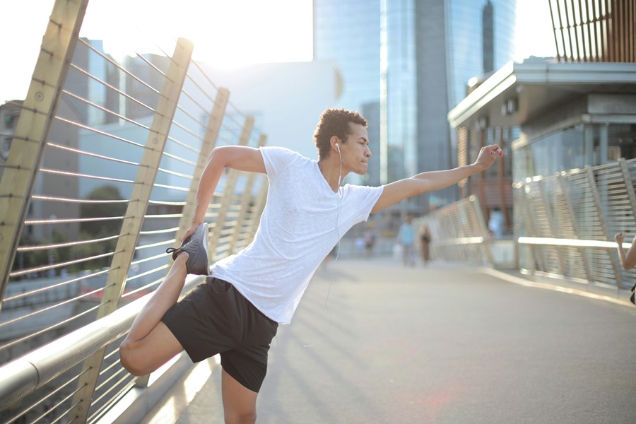 Transform 20 Week 6 Workouts and Tips a Man Stretching Outdoors Before a Run