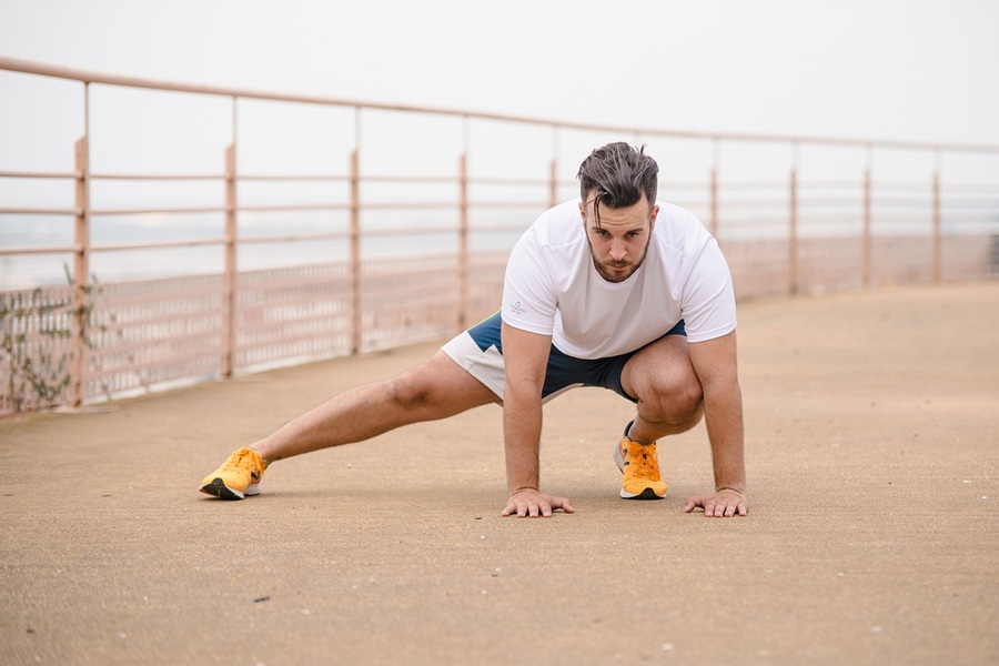 Transform 20 Week 4 Workouts and Tips a Man Stretching His Legs Before a Workout