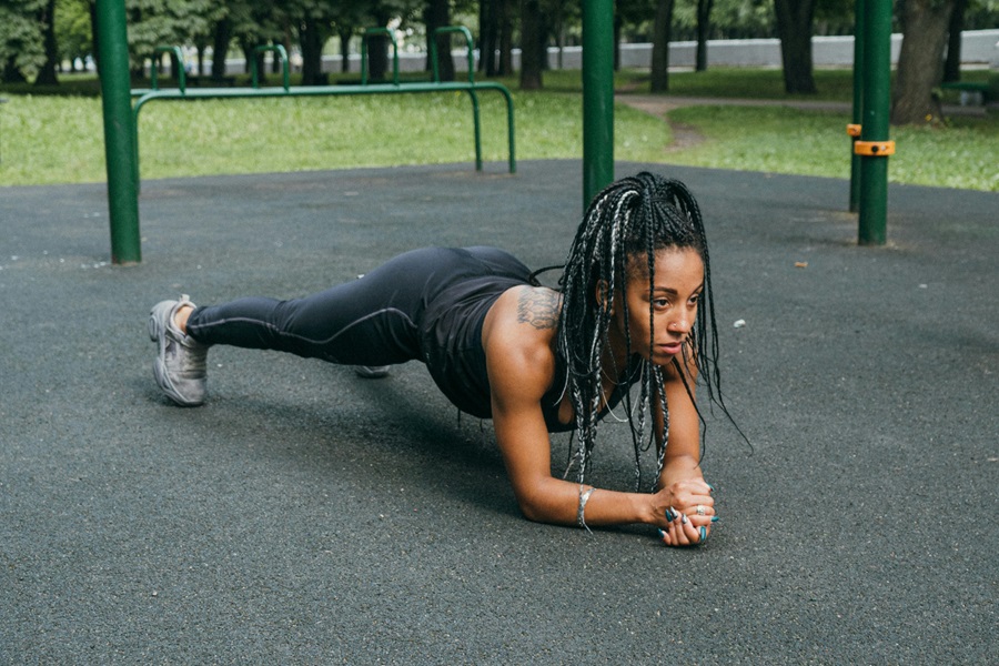Transform 20 Week 6 Workouts and Tips a Woman Doing Planks Outdoors