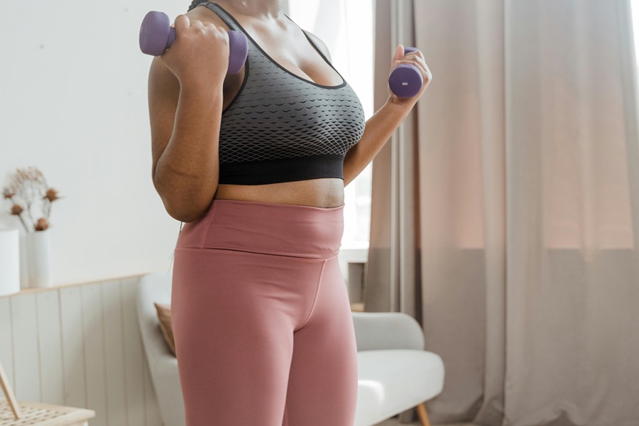 Transform 20 Week 6 Workouts and Tips a Woman Doing a Workout with Two Dumbbells
