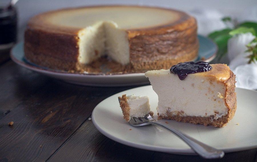 Low Carb Desserts with Cream Cheese a Cheesecake with a Slice Cut Out and Place on a Plate In Front of the Cake