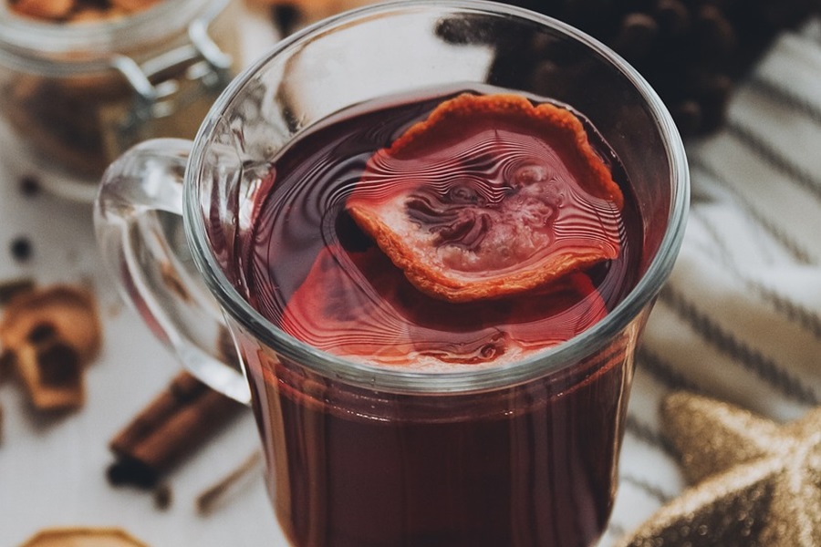 Warm Wine Recipe Spices Close Up of a Glass of Mulled Wine with a Slice of Orange Inside