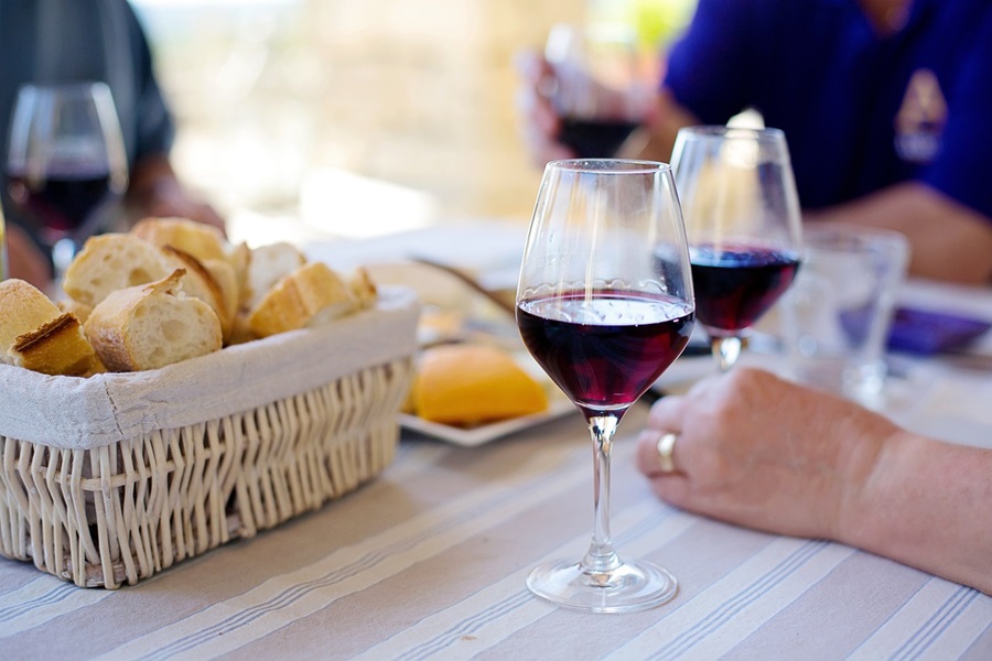 Warm Wine Recipe Spices People Sitting at a Picnic Table Drinking Red Wine