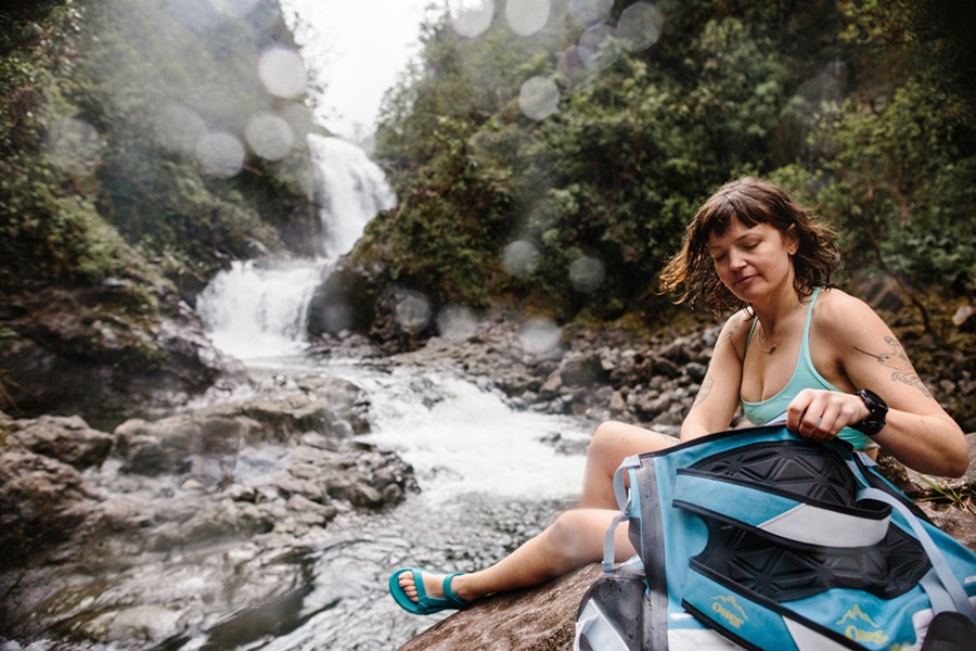 Otterbox Trooper Coolers Features and Review a Woman Sitting on a River with a Cooler