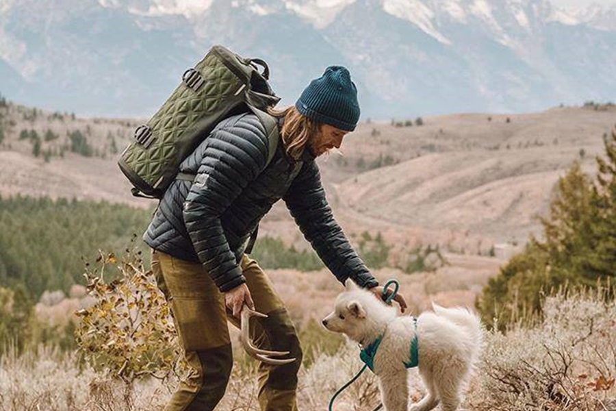 Otterbox Trooper Coolers Features and Review a Man Hiking with His Dog While Wearing a Cooler on His Back