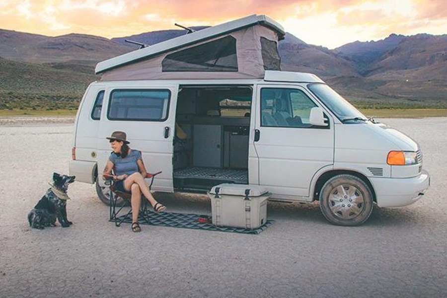 Otterbox Trooper Coolers Features and Review a Woman Sitting in a Folding Chair by a Van with a Cooler in a Desert 