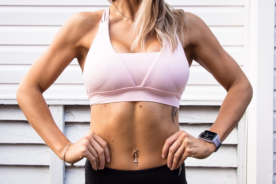 21 Reasons to Try 21 Day Fix Workouts Close Up of a Woman Wearing Workout Clothes Posing with Her Hands on Her Hips
