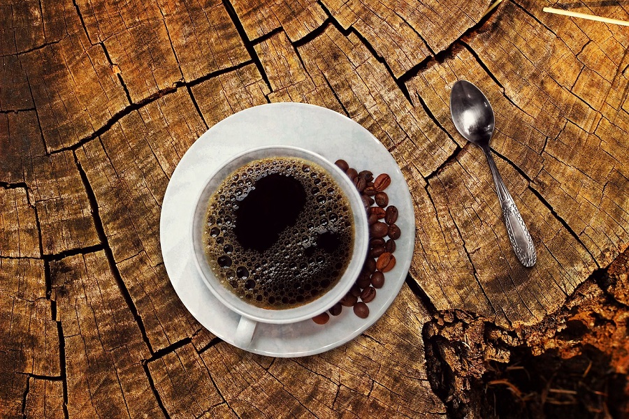 Intermittent Fasting Coffee Recipes Overhead View of a Cup of Black Coffee on a Wooden Stump