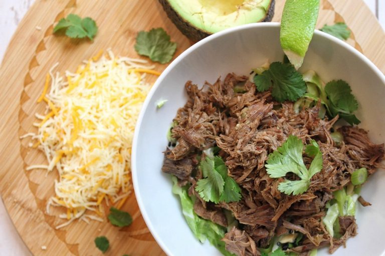 Low Carb Crock Pot Beef Barbacoa Overhead View of Beef in a Bowl with Cilantro and Shredded Cheese