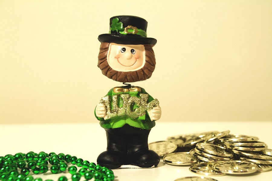 Green Margaritas for St Patricks Day Tiny Leprechaun Figure On a Table with Gold Coins and Green Beads