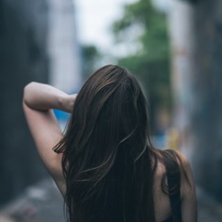 Fine Hair Care Routine Woman With Her Hand in Her Hair