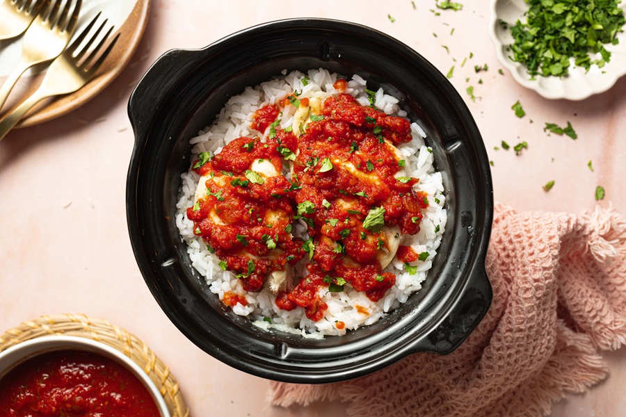 Salsa Chicken and Rice Recipe Overhead View of a Crockpot with White Rice and Salsa Chicken Inside