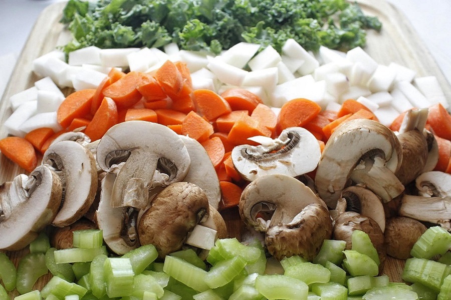2B Mindset Crock Pot Recipes Close Up of Celery, Mushrooms, Carrots, Onions and Kale All Chopped and Split into Neat Rows