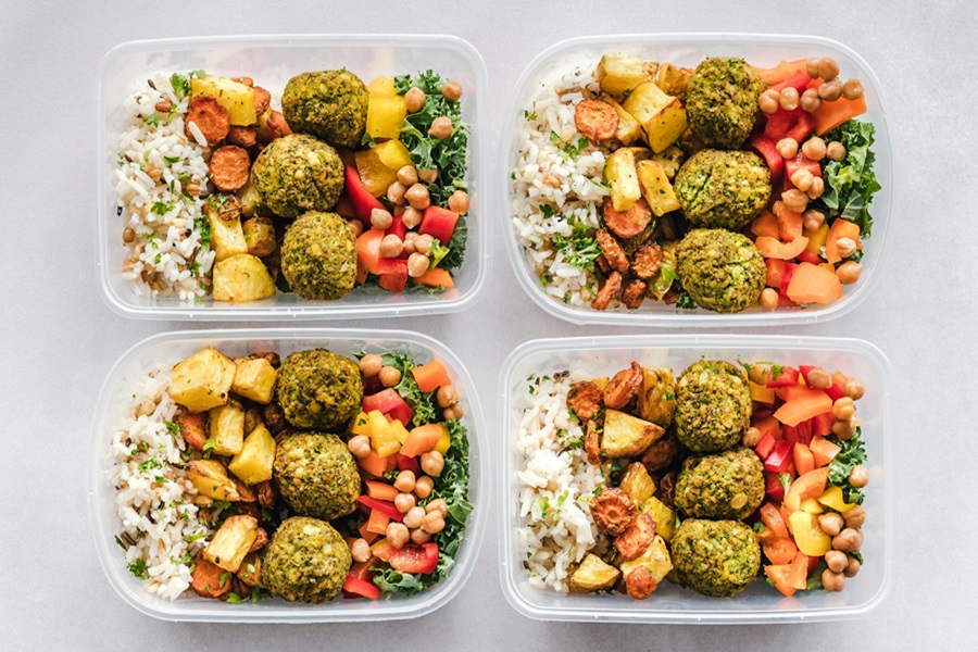 Beachbody 2B Mindset FAQ Overhead View of 4 Meal Prep Containers Filled with Healthy Food