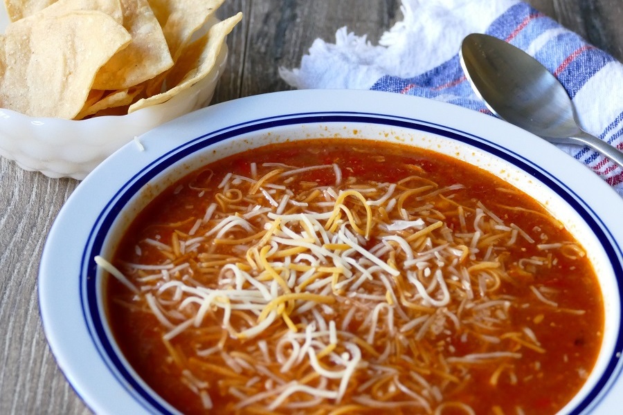 Low Carb Lunch Ideas Close Up of a Bowl of Tortilla Soup with Shredded Cheese and Tortilla Chips