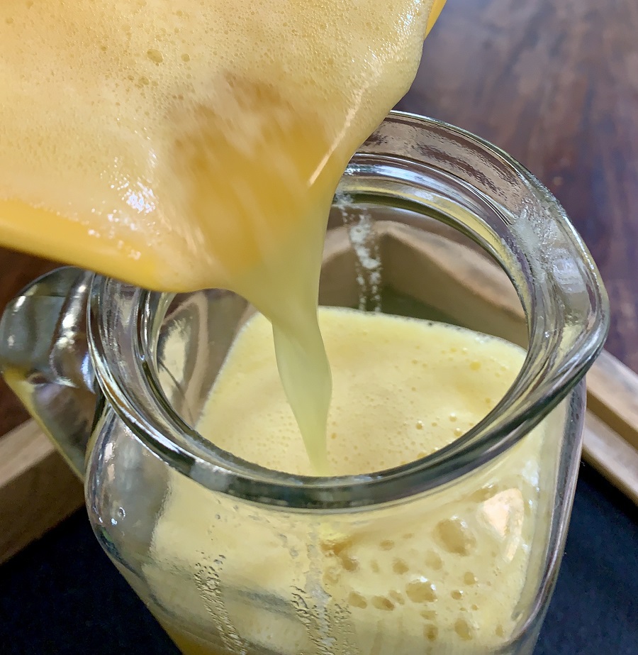 How to Make Fresh Pineapple Juice Being Poured into a Glass Jug