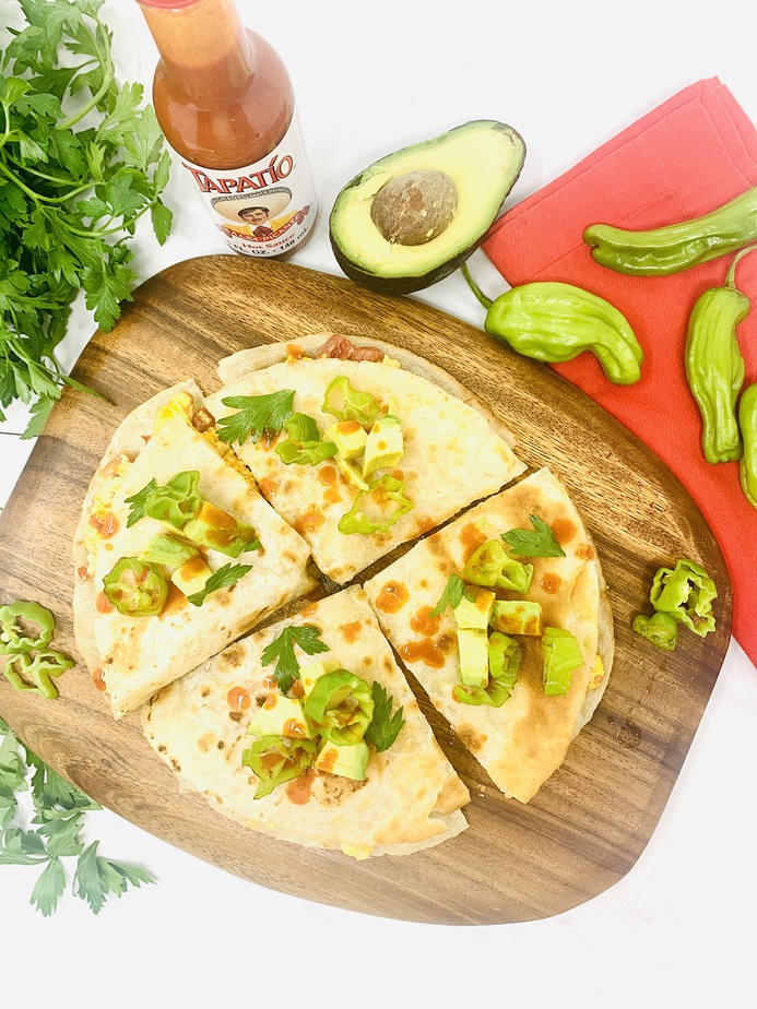 Healthy Breakfast Quesadilla Recipe Quesadilla on a Cutting Board Cut into 4