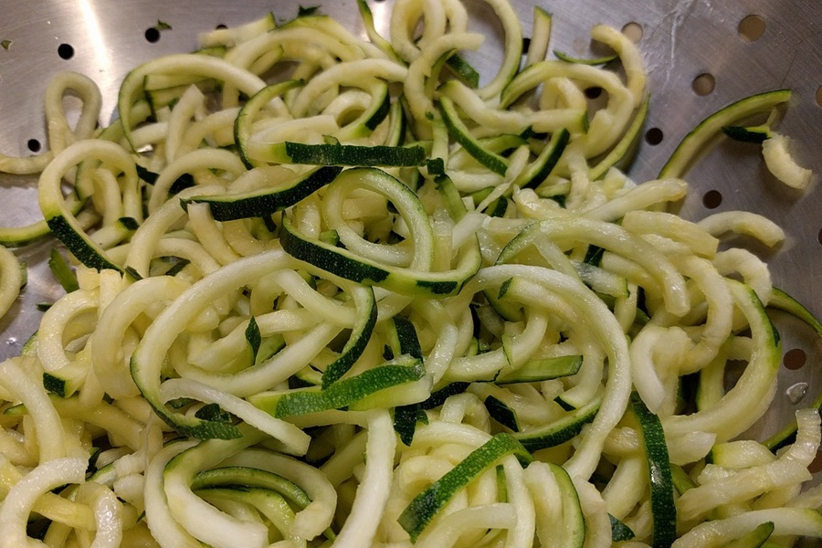 Zoodles and Meat Sauce Recipe Close Up of Zucchini Noodles in a Strainer