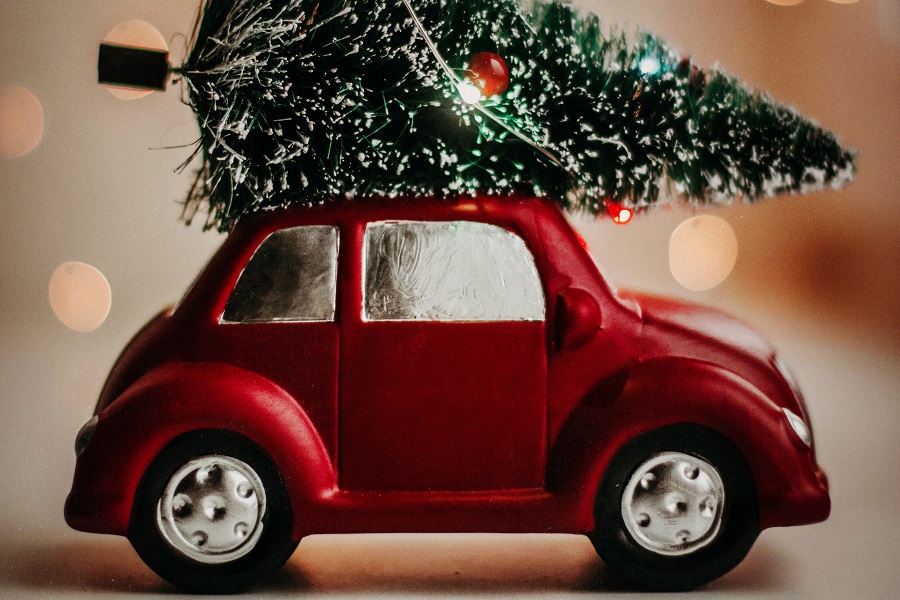 Elf Introduction Ideas for Elf on the Shelf Close Up of a Small Toy Car with a Small Toy Christmas Tree On Top
