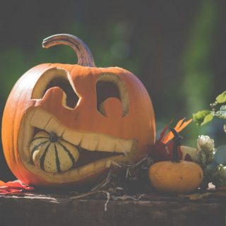 Halloween Crockpot Recipes Carved Pumpkin Holding Another Pumpkin in its Mouth