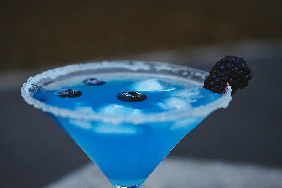 Halloween Cocktails Close Up of a Blue Cocktail with Blueberries Floating Inside