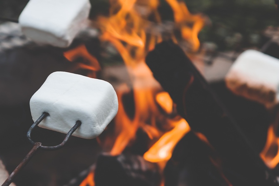 Easy Crockpot Thanksgiving Desserts Close Up of Marshmallows Being Roasted Over an Open Fire