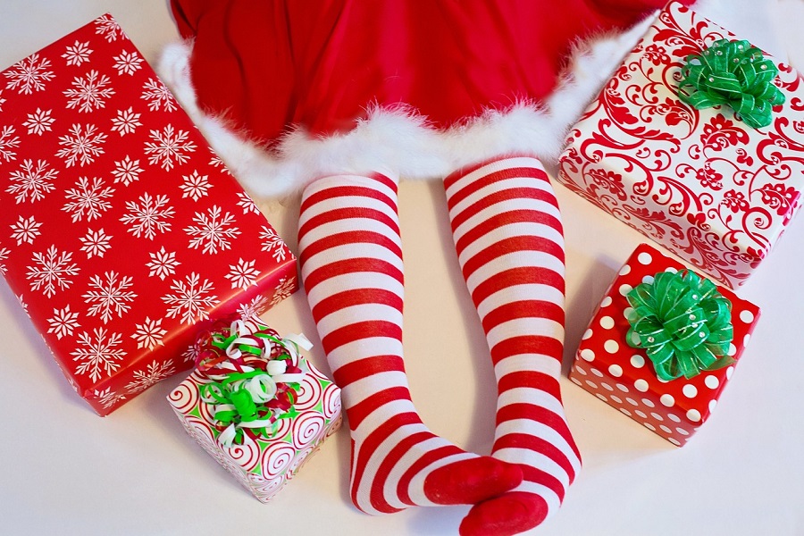 How to Say Goodbye to Elf on the Shelf a Little Girl Wearing Red and White Stripped Leggings Sitting Next to Presents