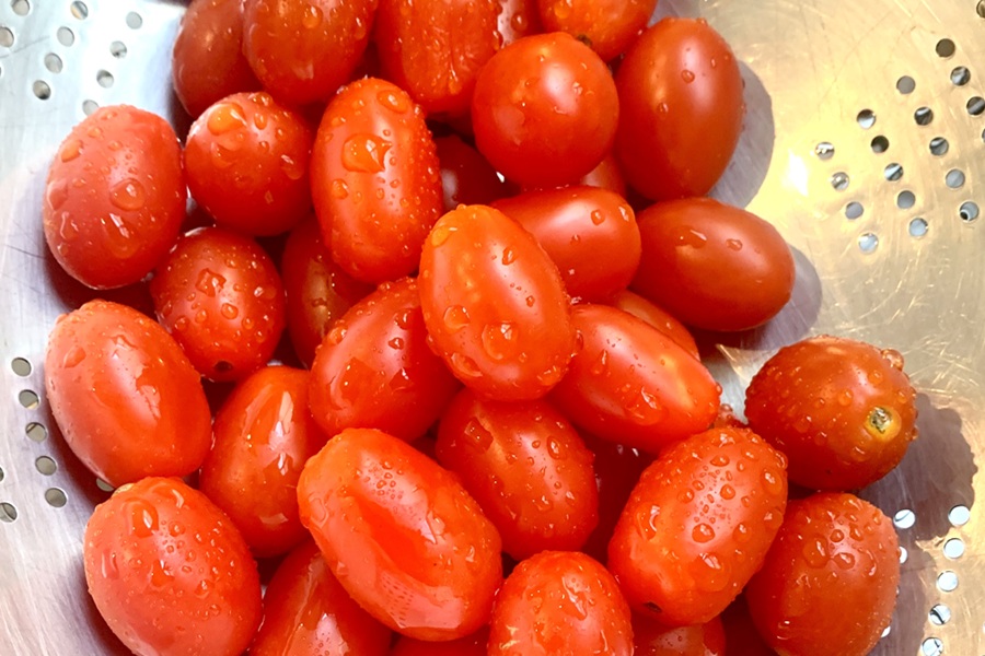 Chicken and Tzatziki in Pita Pockets Close Up of Cherry Tomatoes in a Strainer