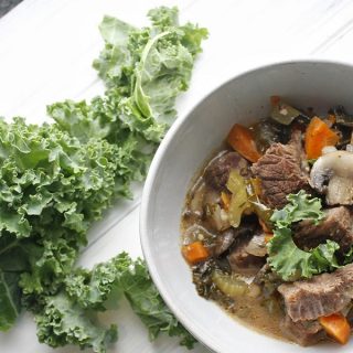 2B Mindset Instant Pot Beef Stew Overhead View of a Bowl of Stew with Fresh Kale Next to it