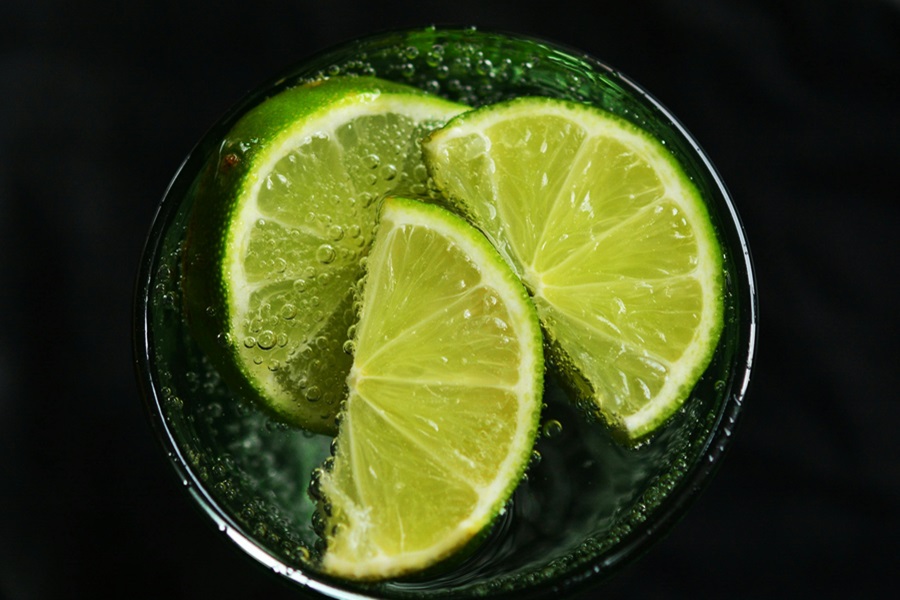 Easy Jillian Michaels Detox Tips Overhead View of a Glass of Water with Lime Wedges Inside