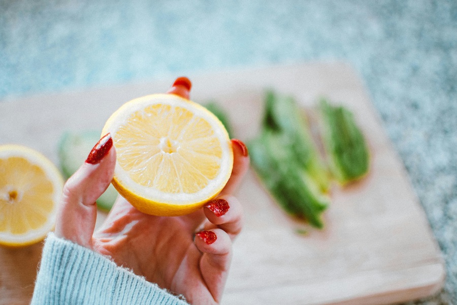 Jillian Michaels Detox Close Up of a Woman's Hand Holding a Lemon Cut in Half