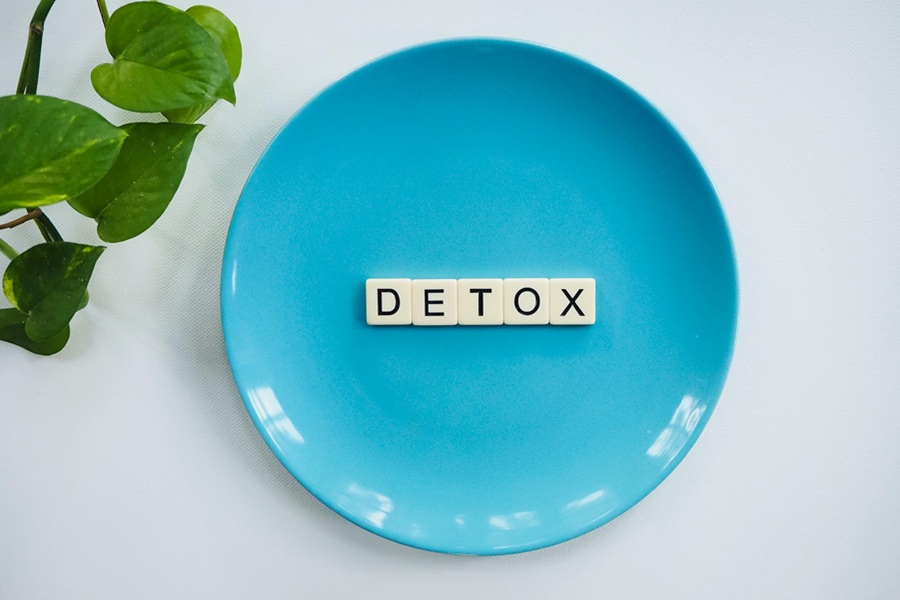 Jillian Michaels Detox a Blue Plate with Tile Letters On Top Spelling Out DETOX