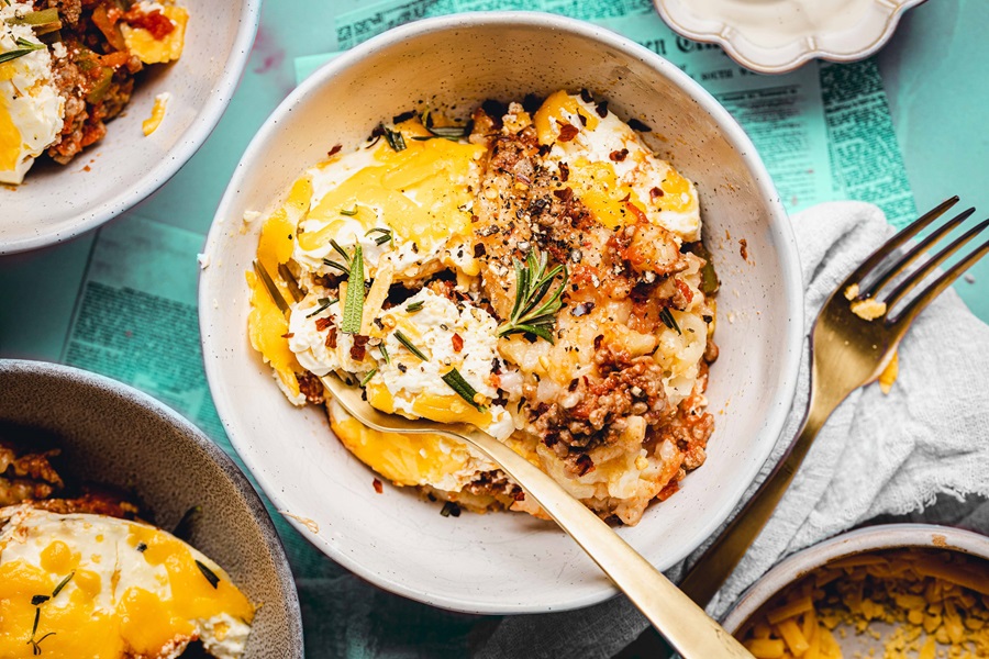 Slow Cooker John Wayne Casserole with Tater Tots Overhead View of a Bowl of Casserole with a Spoon