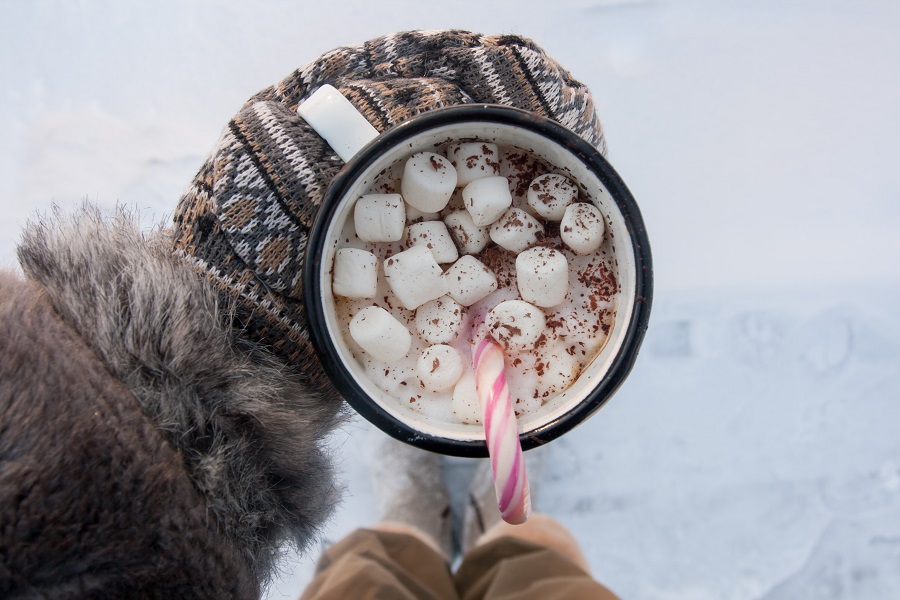 Slow Cooker Spiked Peppermint Hot Chocolate Recipes Person Holding a Cup of Hot Chocolate in the Snow
