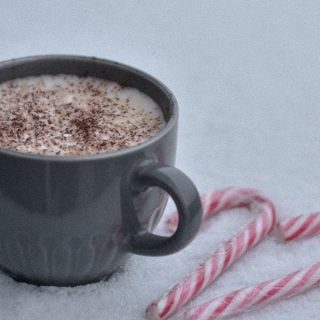 Slow Cooker Spiked Peppermint Hot Chocolate Recipes a Cup of Hot Chocolate in the Snow with Candy Canes Next to it