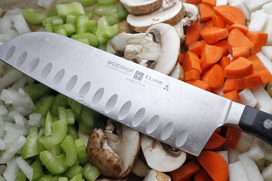 2B Mindset Recipes Close Up of a Knife Laying on a Bed of Diced Veggies Separated into Rows