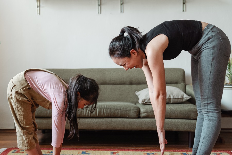Beachbody Hybrid Calendars for LIIFT4 Workouts a Mom and Daughter Doing Yoga in Front of a Couch