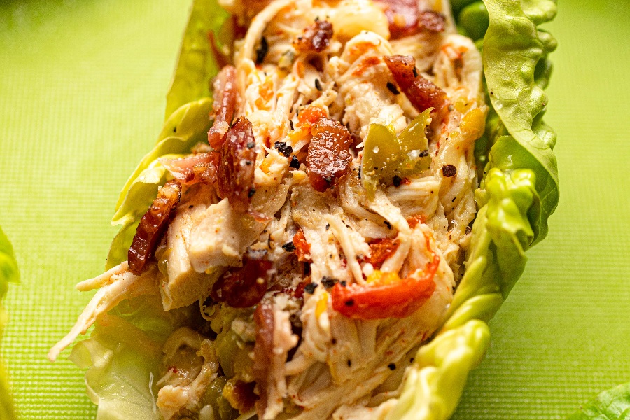 Crockpot Chicken and Bacon Keto Extreme Close Up of a Lettuce Wrap on a Green Surface