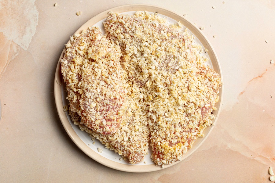 Best Panko Chicken Parmesan Recipe Close Up of Raw Chicken Breasts Covered in Breading