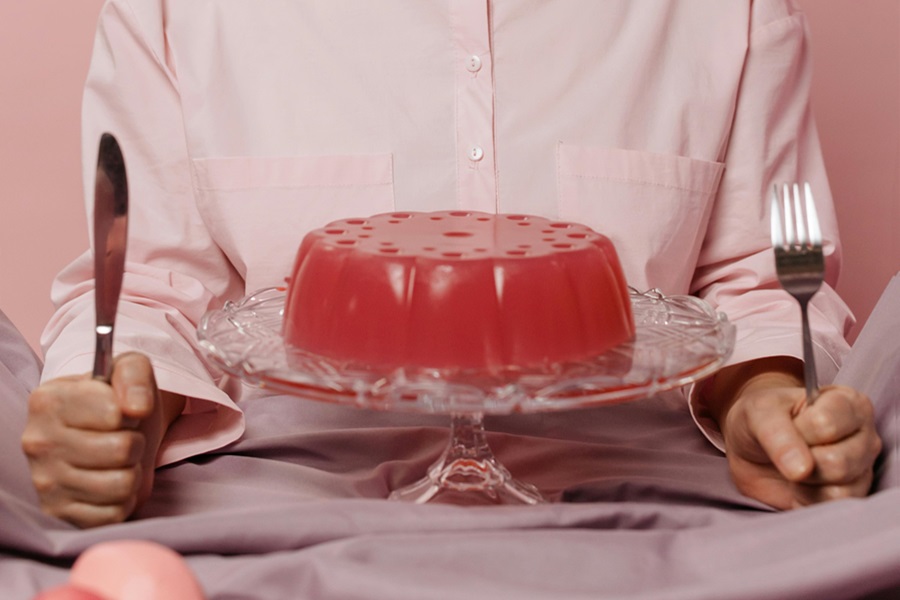 5 April Fools Jokes for Young Kids a Serving Dish of Jell-O in Front of a Woman Holding a Fork and a Knife on Either Side of the Dish