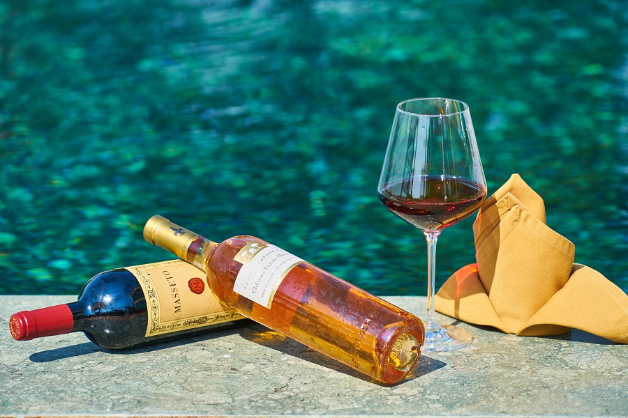 Easy Appetizers Close Up of Two Wine Bottles Next to a Wine Glass Sitting Next to a Pool