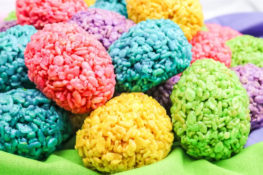 Rice Krispies Treats for Easter Close Up of a Basket Filled with Rice Krispies Treats in Bright Colors Shaped Like Eggs