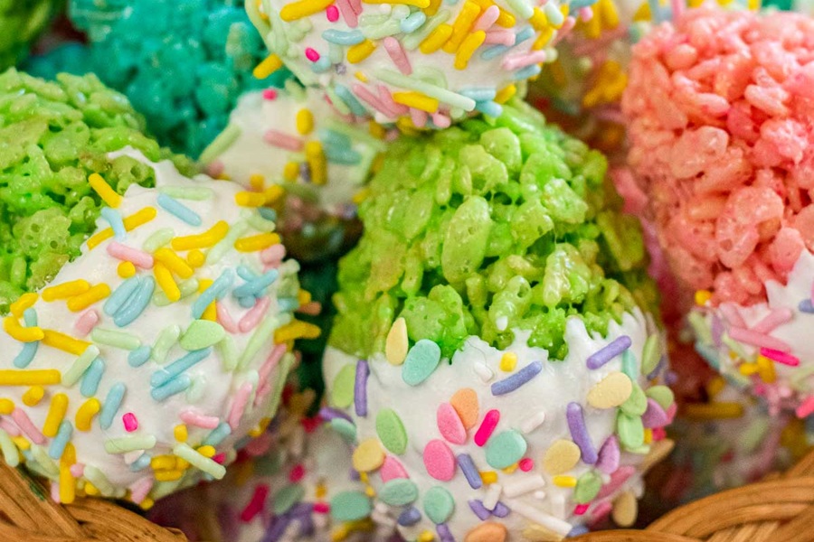Rice Krispies Treats for Easter Close Up of Rice Krispies Treats Shaped Like Eggs in Different Colors with Icing on the Bottom of Each